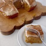 pumpkin cake with espresso frosting sliced on wood cutting board