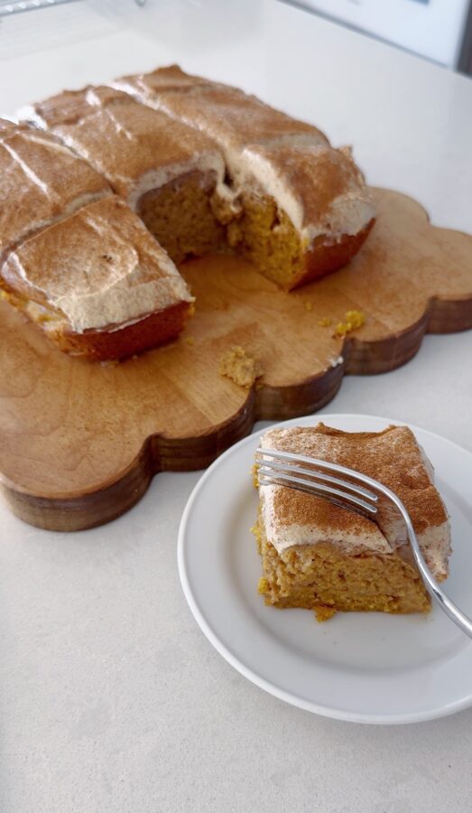 pumpkin cake with espresso frosting sliced on wood cutting board