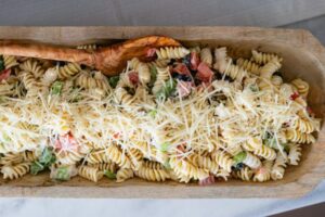 a wooden bowl of ranch pasta salad